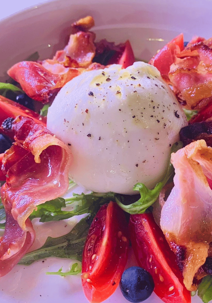 Fresh salad with creamy burrata at Domus Italia in Manchester.